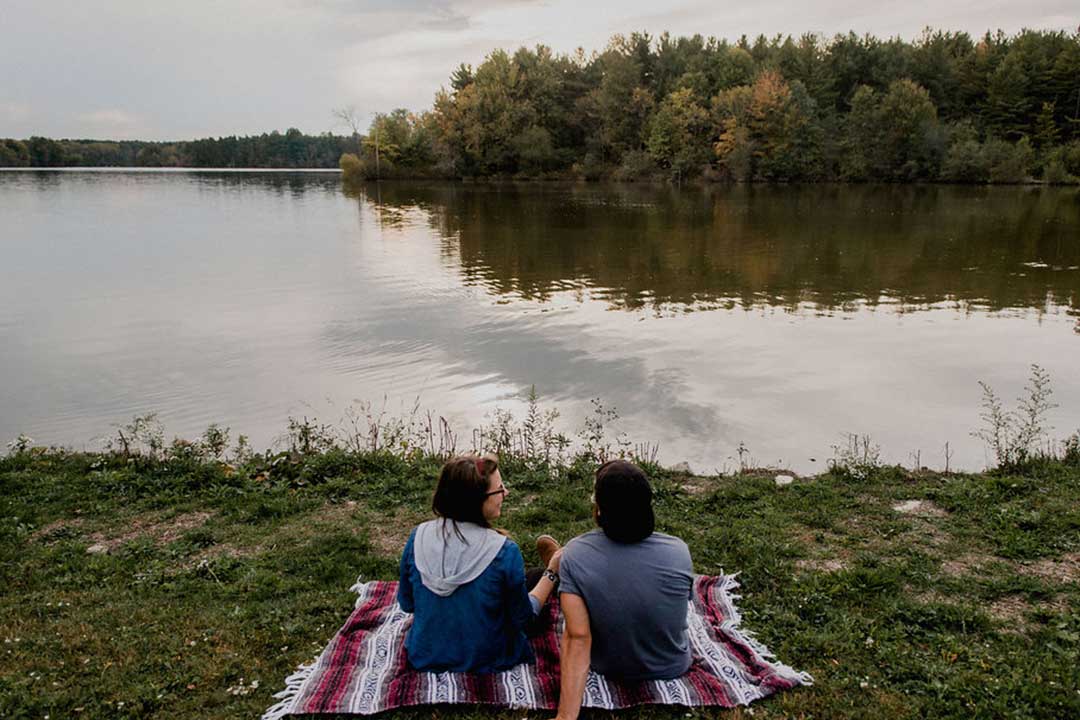 Couple on Blanket looking over Reservoir