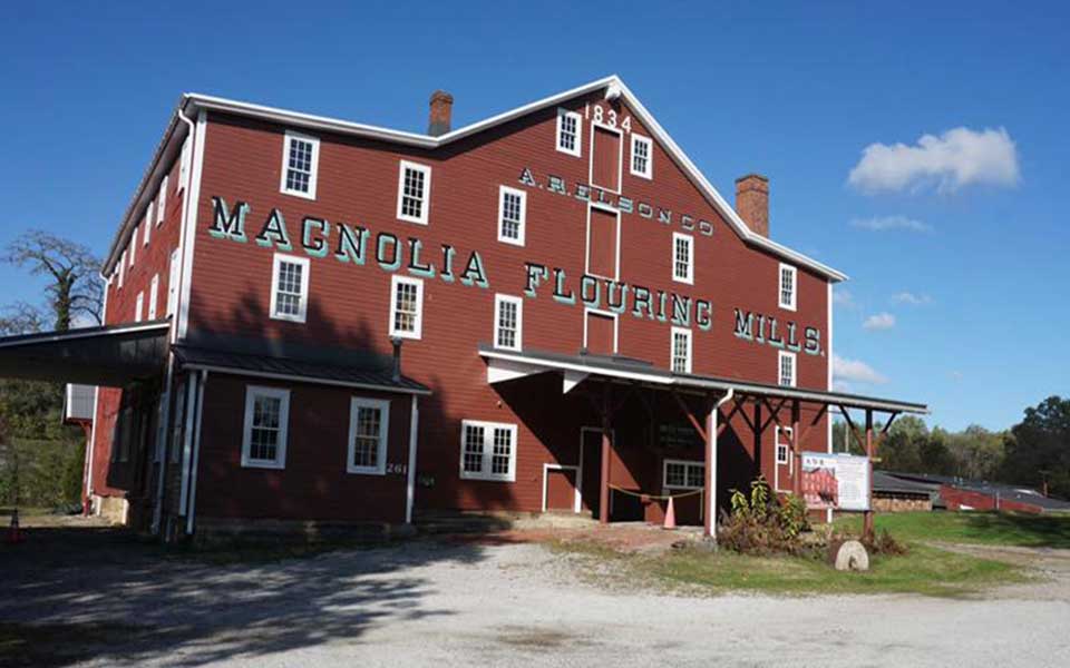 Multi Story Building with Magnolia Flouring Mills text on front