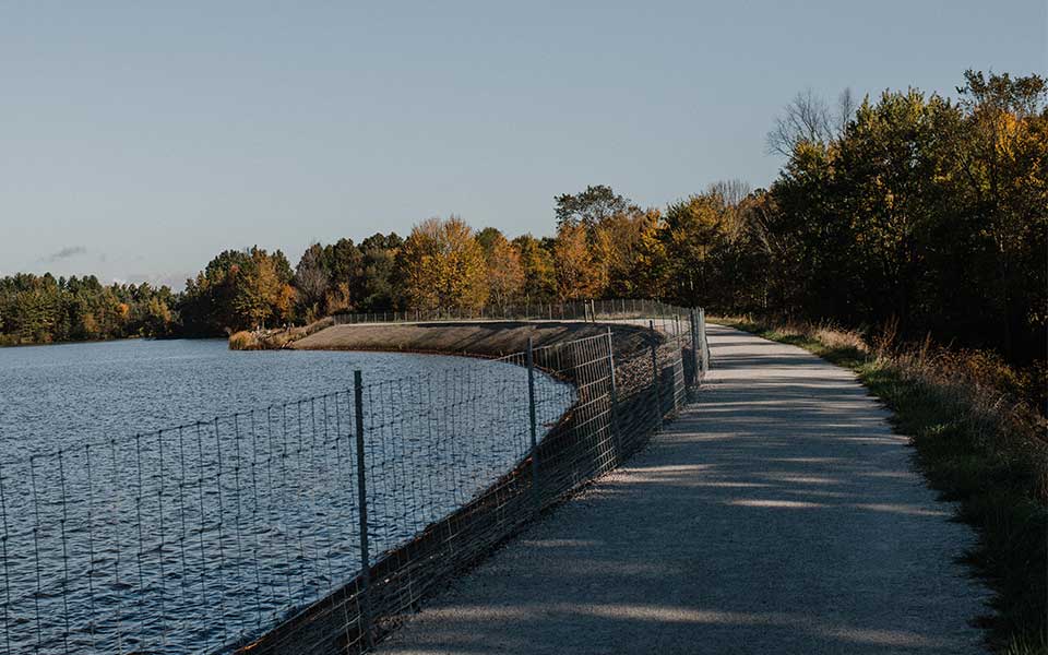 Mahoning Valley Trail with fence and reservoir on side