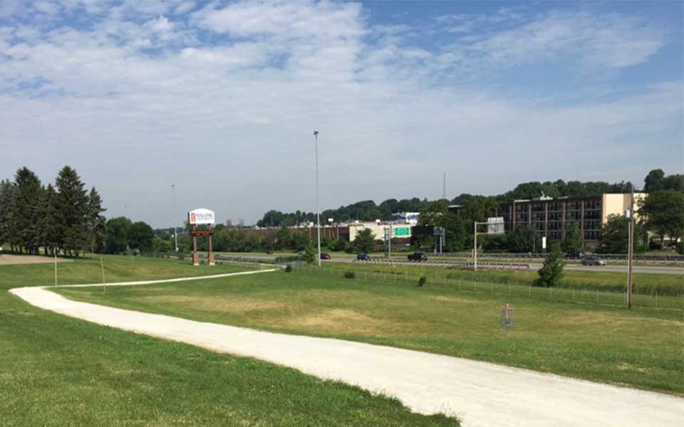 Trail with limestone surface winding next to highway