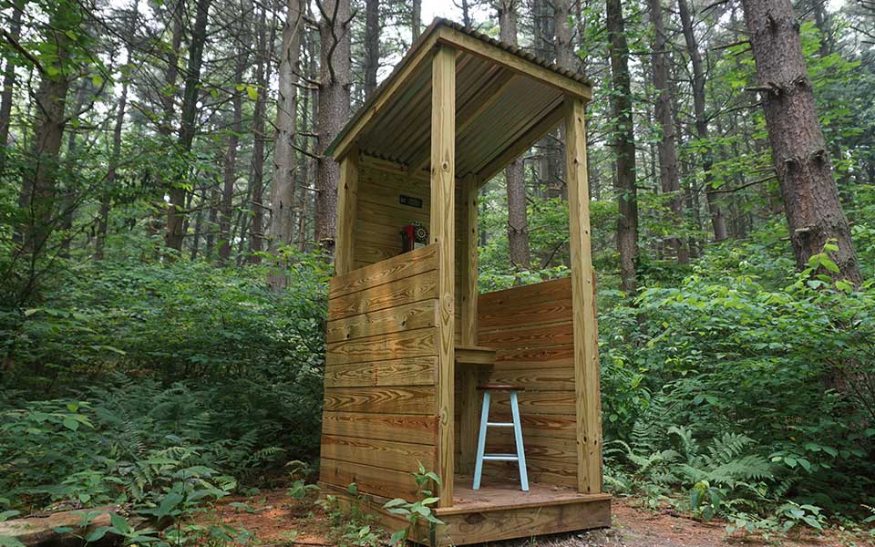 Wooden booth with disconnected phone inside called Wind Phone