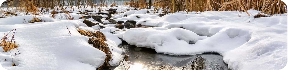 creek running water with snow on banks