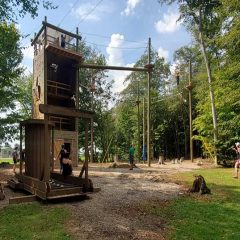 People watching and climbing on high ropes course
