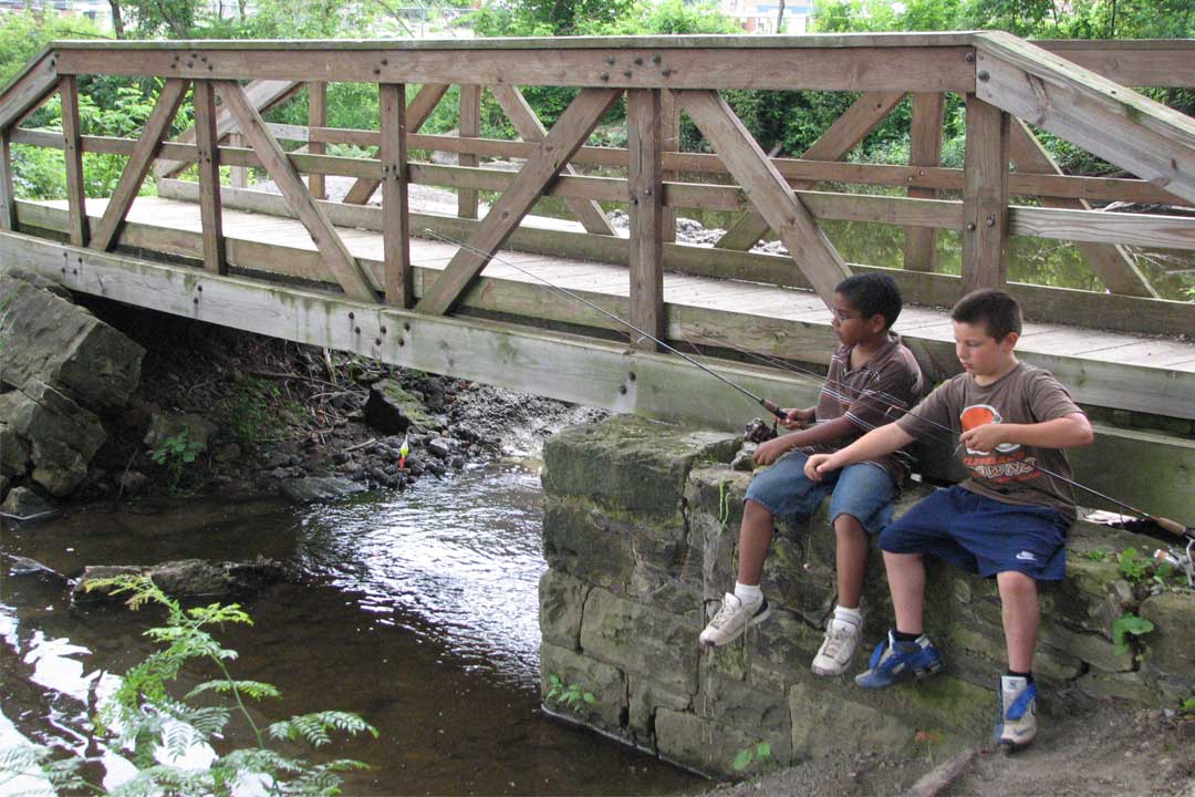 Two boys fishing at Cook's Lagoon Bridge