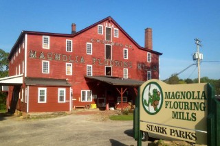 Mill building with sign in front.
